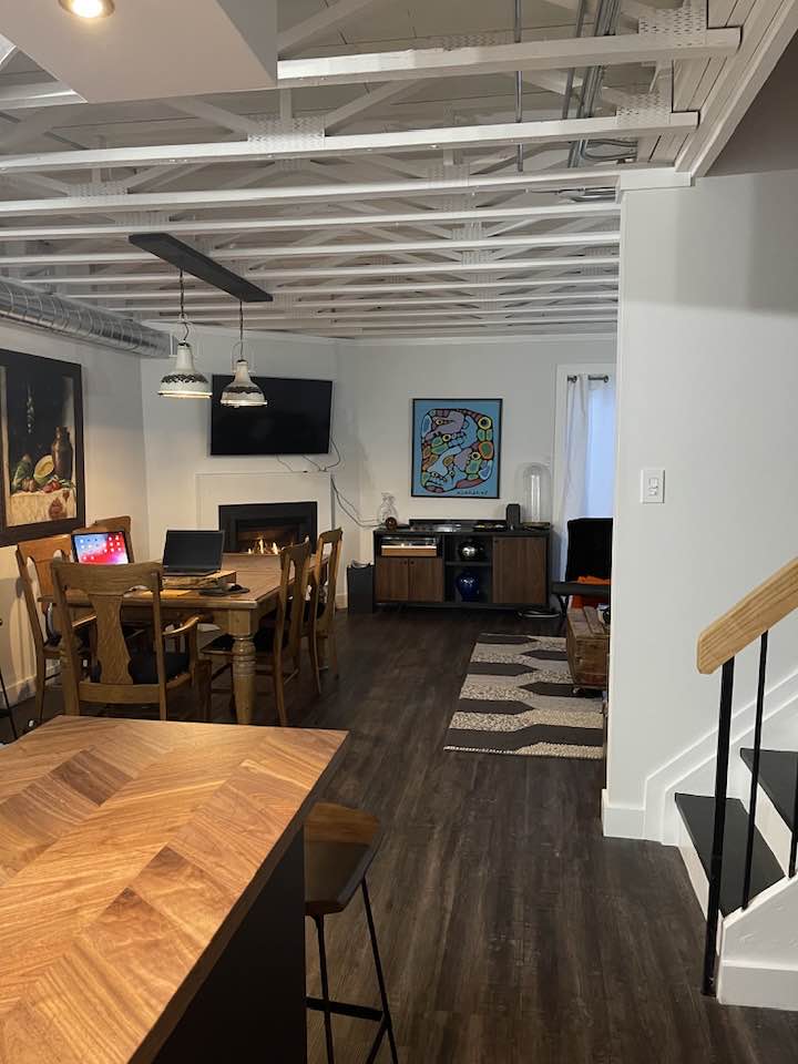 Finished condo interior with painted exposed ceiling beams and modern living space