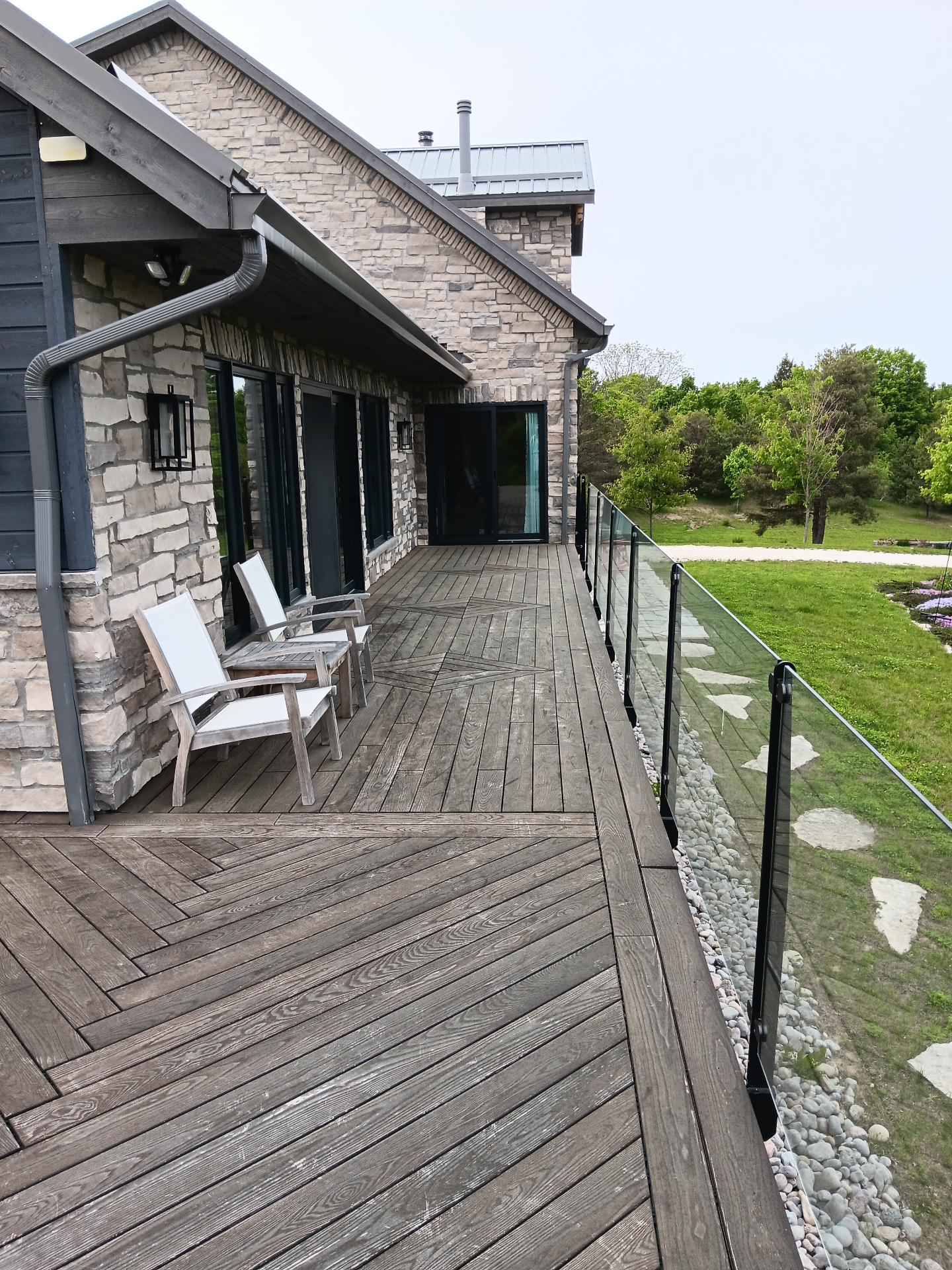 Before deck staining: weathered gray deck with natural wood appearance