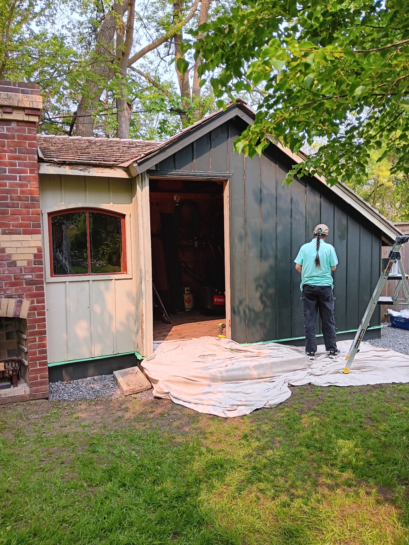 Professional exterior painting in progress - BTR Painting crew working on shed