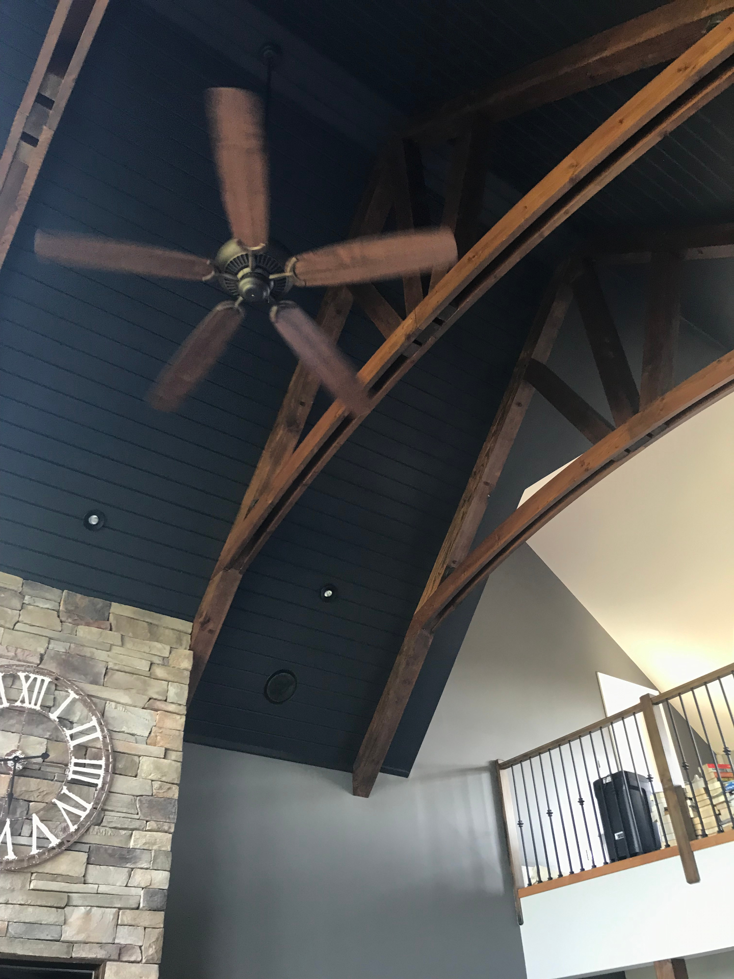 After interior painting: dramatic navy blue vaulted ceiling with natural wood beams