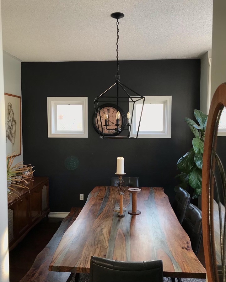 After interior painting: bold dark accent wall in modern dining room